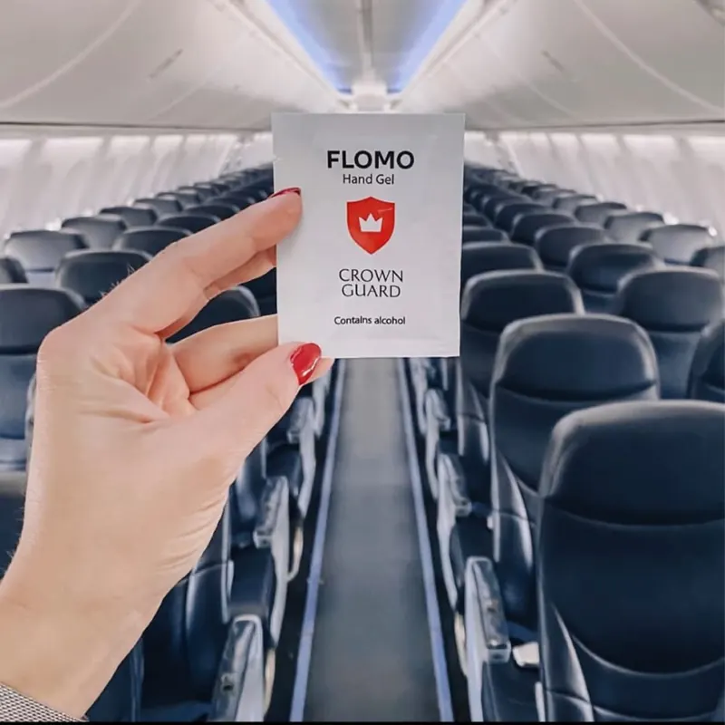 Individually wrapped hand gel sachet inside an aircraft cabin